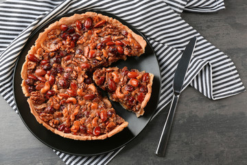 Delicious cake with nuts on table