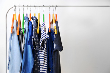 Fototapeta premium Clothes hanging on rack, closeup