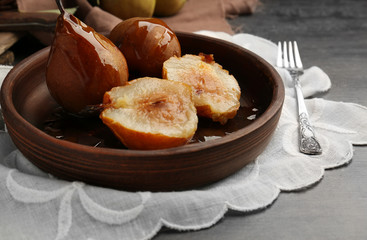 Baked pears served on wooden plate