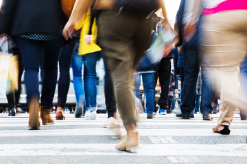 crowd of people crossing a city street