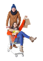 Young man carrying woman in trolley isolated on white