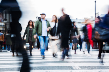 crowd of people crossing a city street