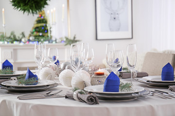 Table served for Christmas dinner in living room, close up view