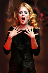 Fototapeta premium Young girl dressed as dead woman for Halloween party, closeup