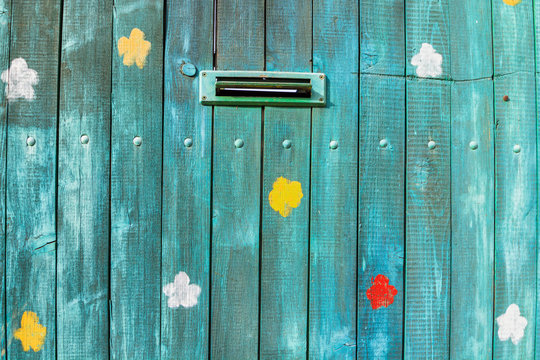 Painted old blue wooden door with mailbox.Close-up shoot