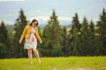 Obraz premium Brunette girl enjoying journey in mountains.
