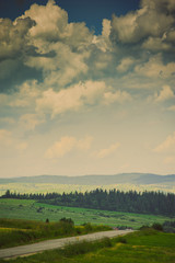 Hills covered with green grass under blue sky