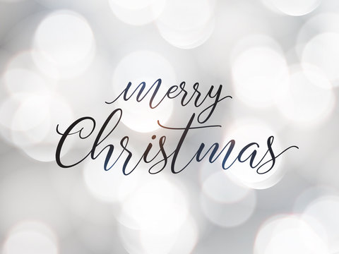 Merry Christmas greeting card. Typographic vector design, beautiful white bokeh background.