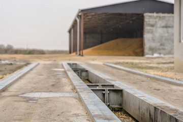 Trucking Weigh Station with grain tank in background