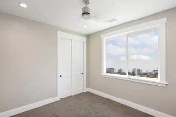 Empty room interior with, ceiling fan, carpet with small walk-in