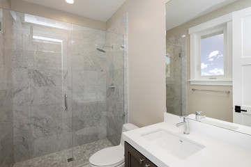 Modern Bathroom with marble and glass shower.