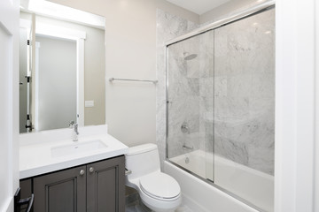 New Bathroom with marble and glass shower.
