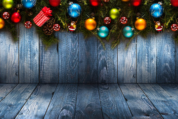 2017 Happy New Year seasonal background with real wood green pine, colorful Christmas baubles, gift boxe and other seasonal stuff over an old wooden aged background