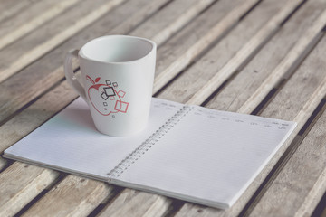 Diary, A cup of coffee on wooden table for background