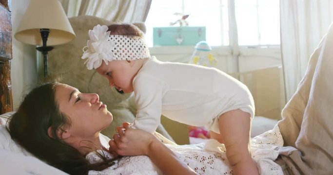  Happy Mother and Baby kissing and hugging, Resting in bed together,  Maternity concept Motherhood Beautiful Happy Family Stock Video Footage in Slow Motion