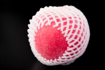 fresh apple wrap with protective foam on black background