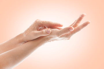 Female hands with scrub on color background. Skin care concept.