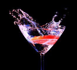 Colorful cocktail with splash on dark background