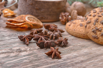 Tasty cookies and anise on wooden background, close up view