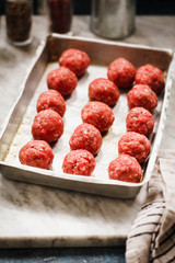 beef meatballs. Chef preparing raw beef meatballs in oven sheet. 