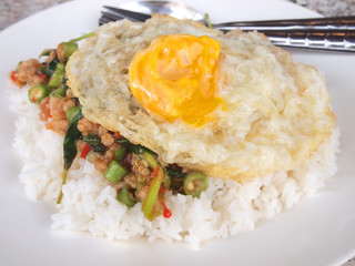 Close up Rice topped with stir fried pork and basil