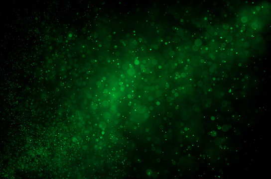 Dark green abstract background with bokeh.