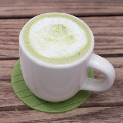 green tea latte on wood background
