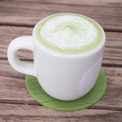 green tea latte on wood background