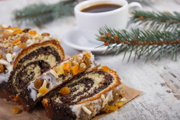 Poppy seeds cake, cup of coffee and spruce branches, dessert for Christmas
