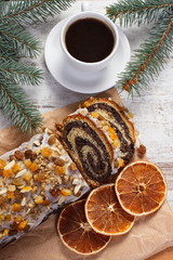 Poppy seeds cake, cup of coffee and spruce branches, dessert for Christmas