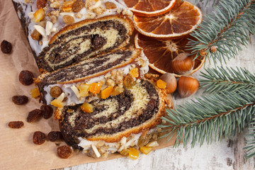 Homemade poppy seeds cake and spruce branches, dessert for Christmas