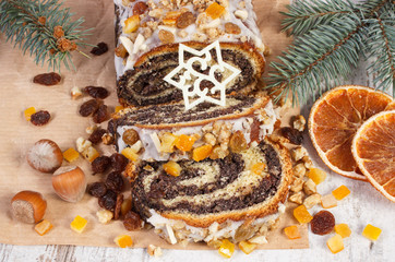 Homemade poppy seeds cake and spruce branches, dessert for Christmas