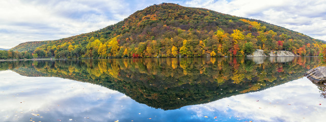 Lake at Bear Mountain in New York State in the autumn season during peak foliage with a clear reflection in the water