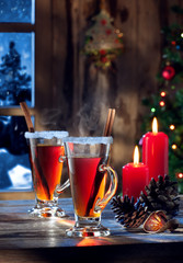 close up view  of two glasses with mulled wine on color back