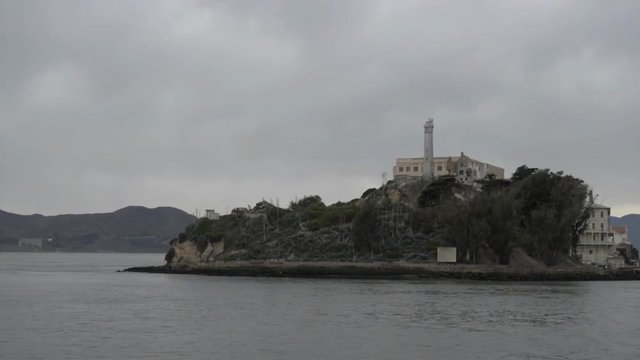 Wide establishing shot of Alcatraz Island, shot from a boat.