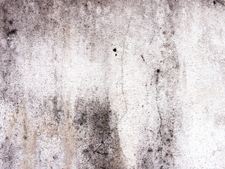 Surface of white walls are old, dirty, rough, black stains Filled with smudges of color decay. abstract background.