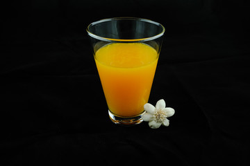 Orange juice. Black background.