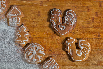 Christmas gingerbread males roosters on a wooden table