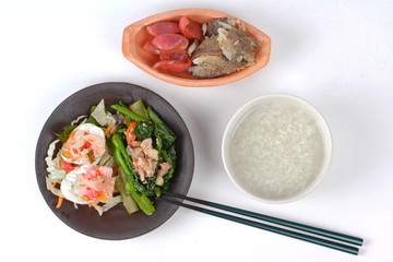 Rice gruel and  side dish as shredded of fried sun-dried fish ,Chinese sausage,spicy salted egg salad and fried kale with salted fish.