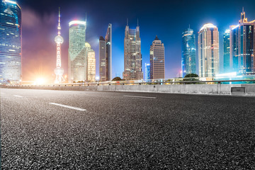 Obraz premium empty asphalt road through modern city in China.