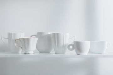 Fototapeta premium Clean cups on wooden shelf