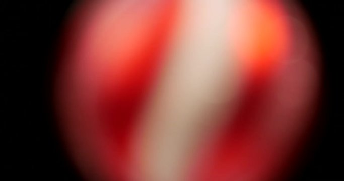 Defocused Spinning christmas striped pattern ball

