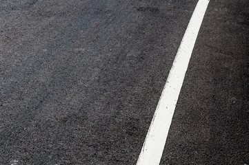 Fototapeta premium White line on new asphalt detail,Street with white line texture