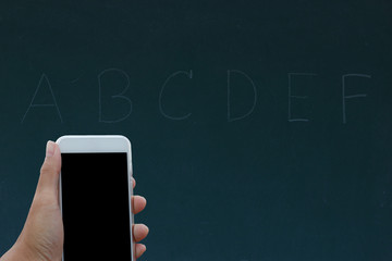 Hand holding phone black clipping inside on black board