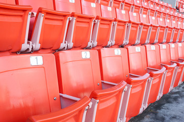 Empty orange seats at stadium,Rows of seat on a soccer stadium