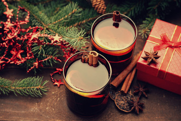 Obraz na płótnie Canvas Hot mulled wine with spices, gift box and lemon 