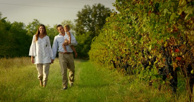 A nice family walk in nature, the family consists of the mother, father and daughter smiling happy and loves. the concept of nature, family, love, freedom