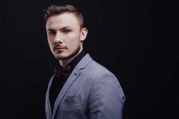 Beautiful guy looking forward on dark background