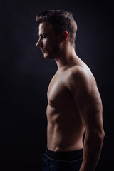 Fototapeta premium Handsome fitness man side view