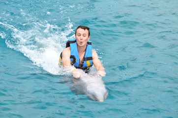 man enjoying dolphin ride © PixieMe